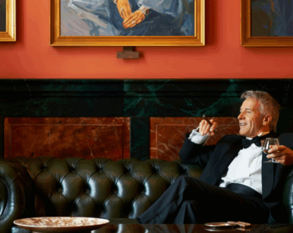 Wealthy Man Sitting on Sofa with a drink and cigar